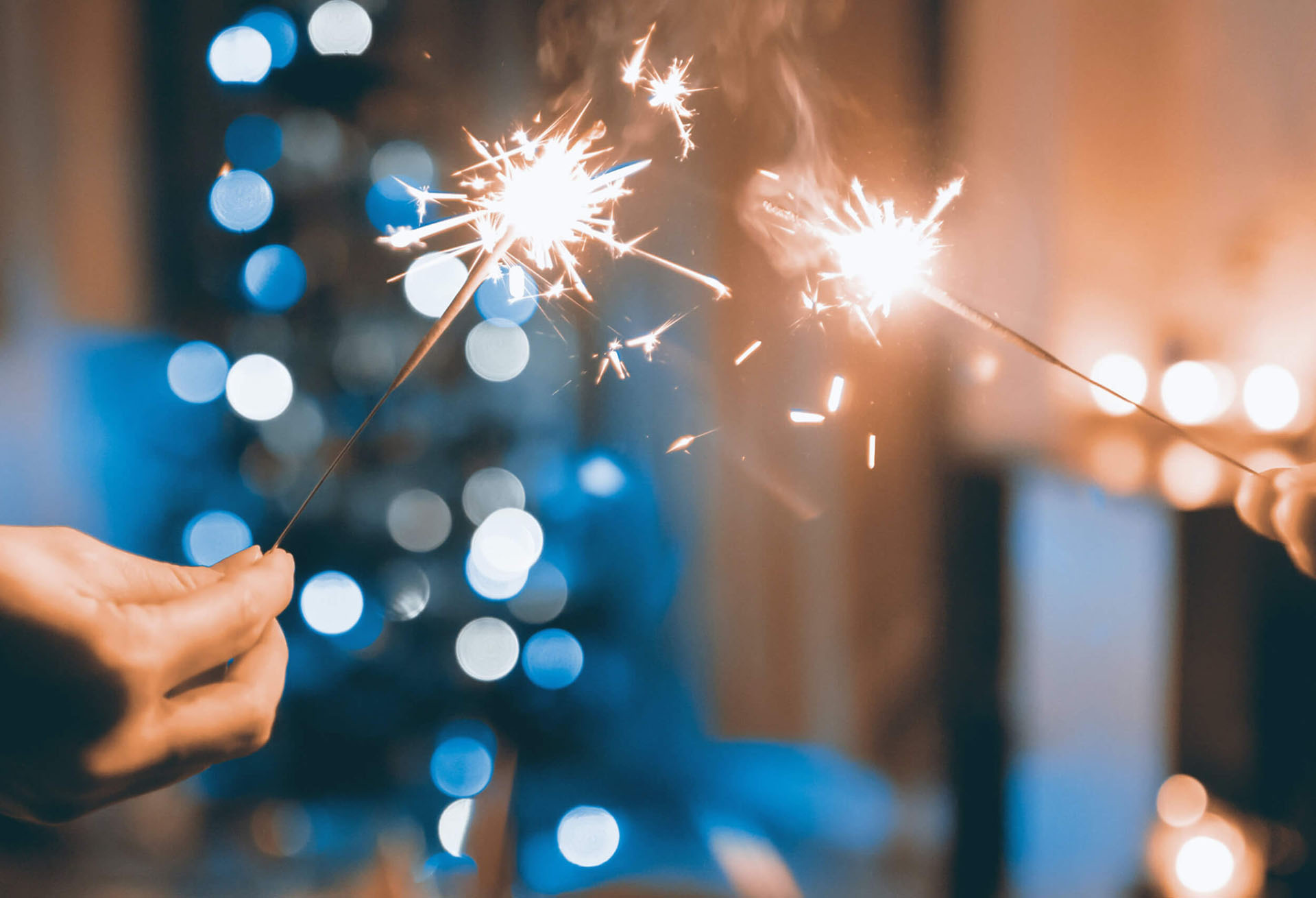 A hand holding a sparkler