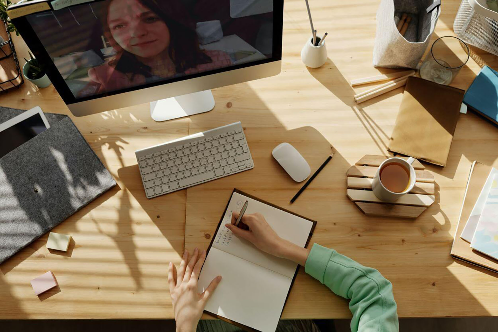 A person working at a desk in front of a computer monitor