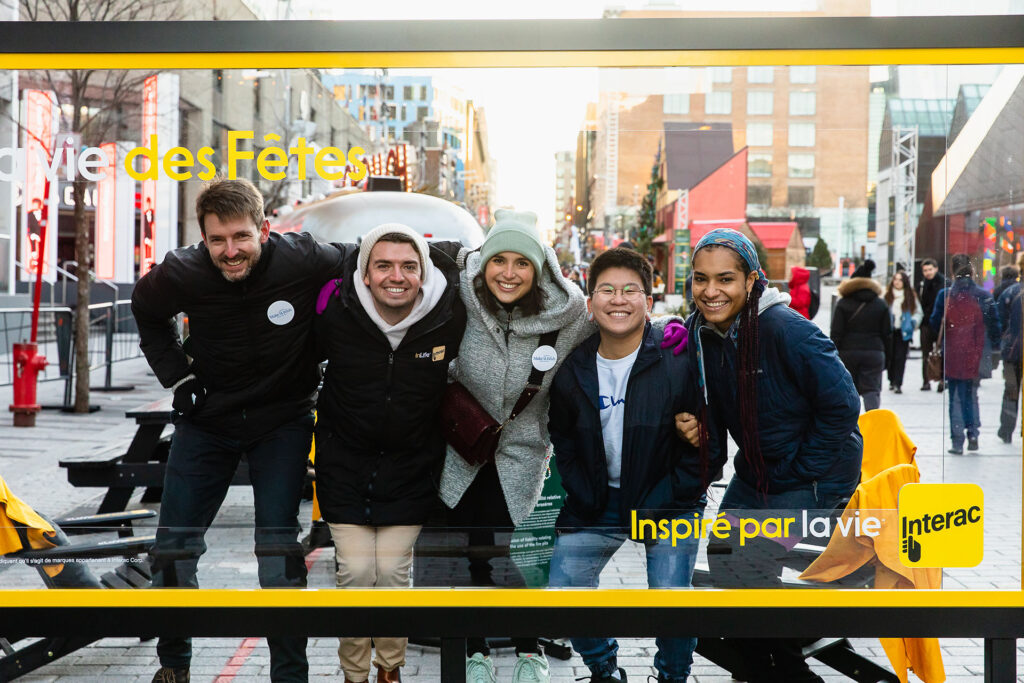 People posing at an Interac activation