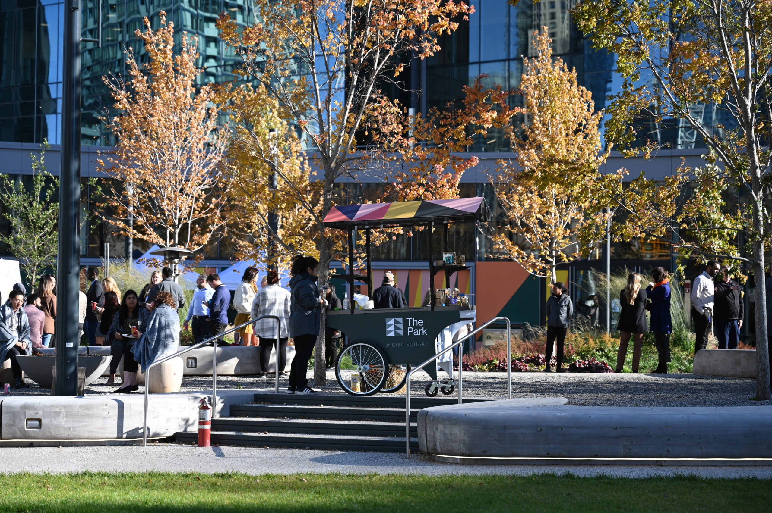 Groups of people hanging out in The Park by CIBC Square