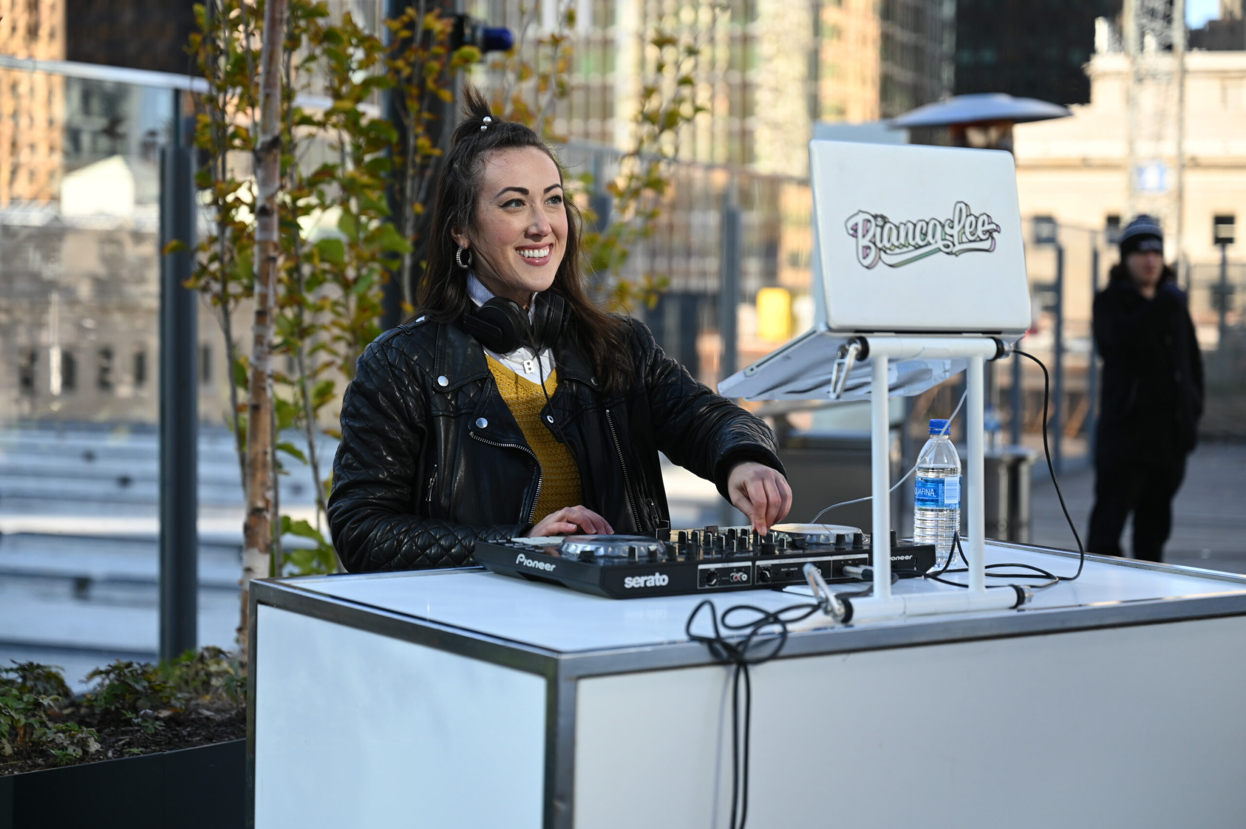 a woman standing at a DJ stand