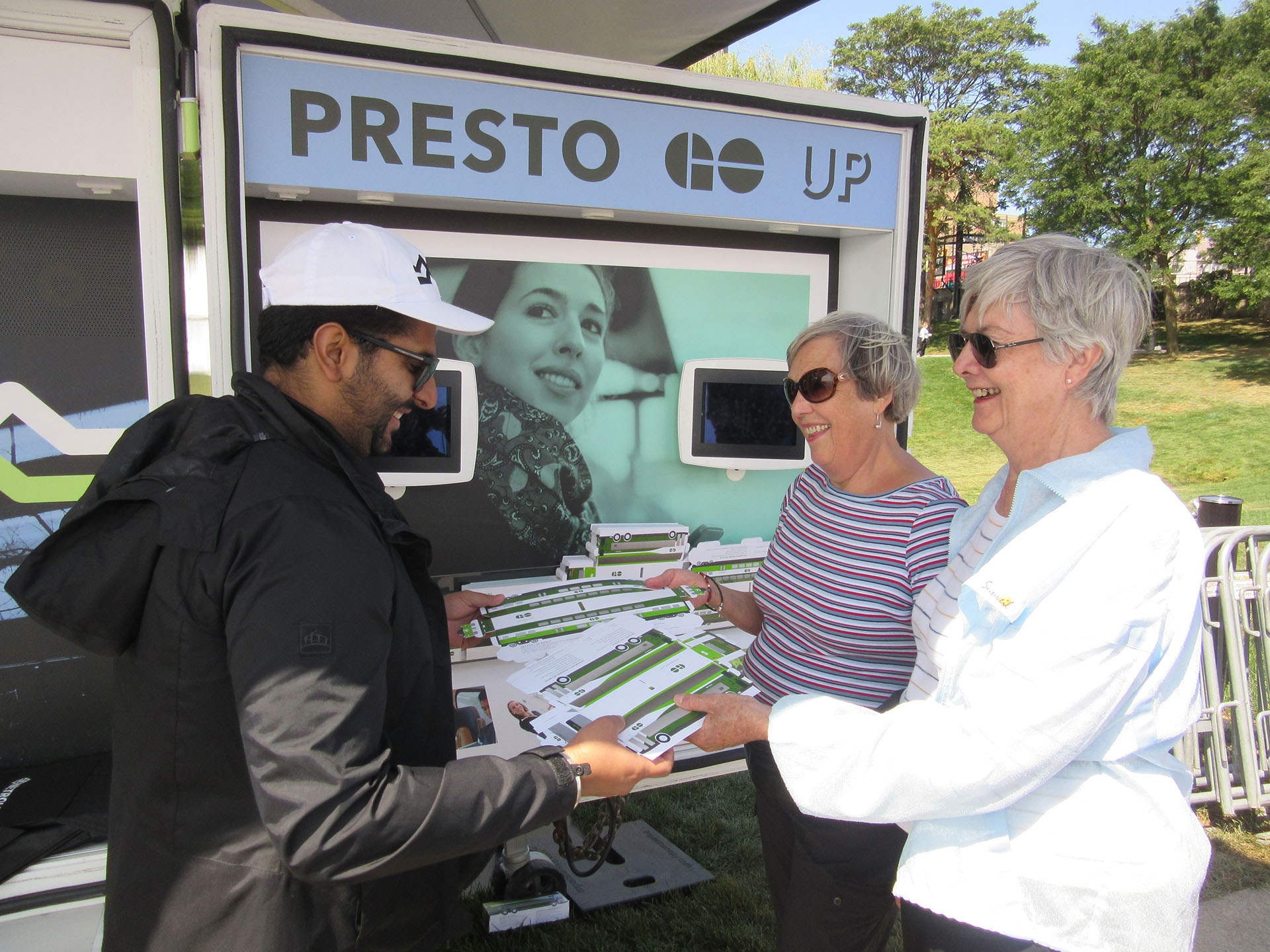 People interacting with a brand ambassador at a Metrolinx activation