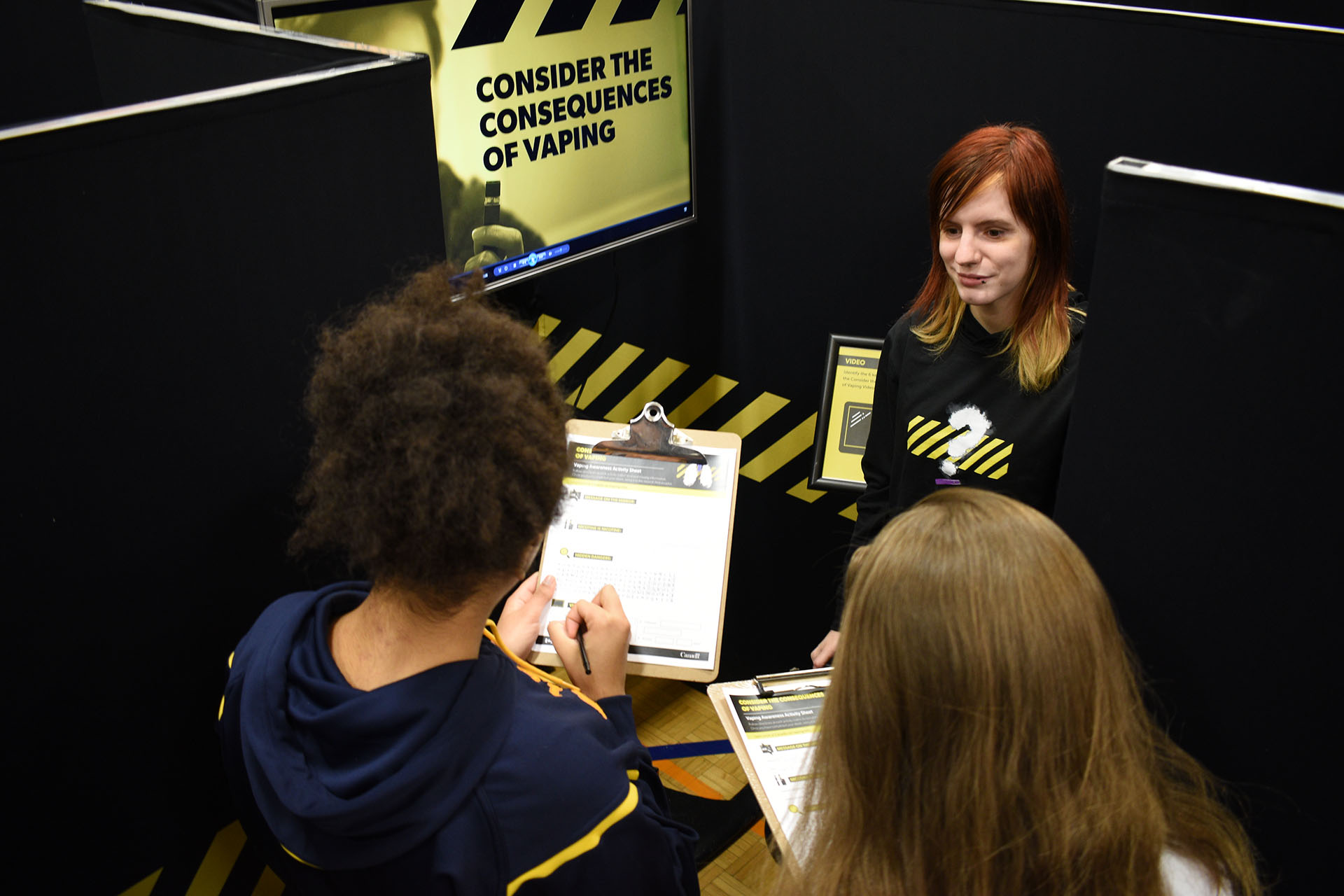 students holding clipboards attending a Health Canada event