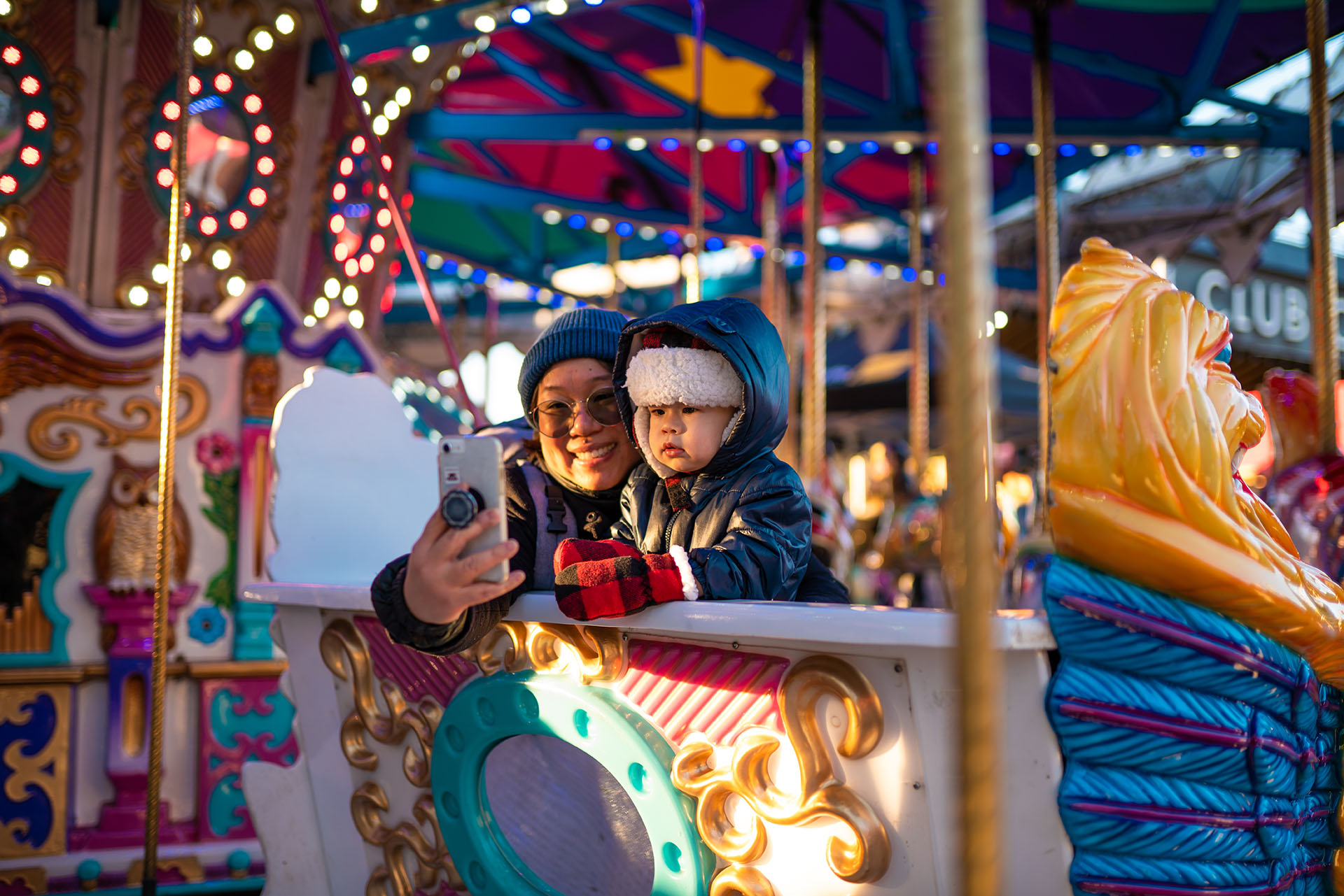 A mother and baby on a merry-go-round