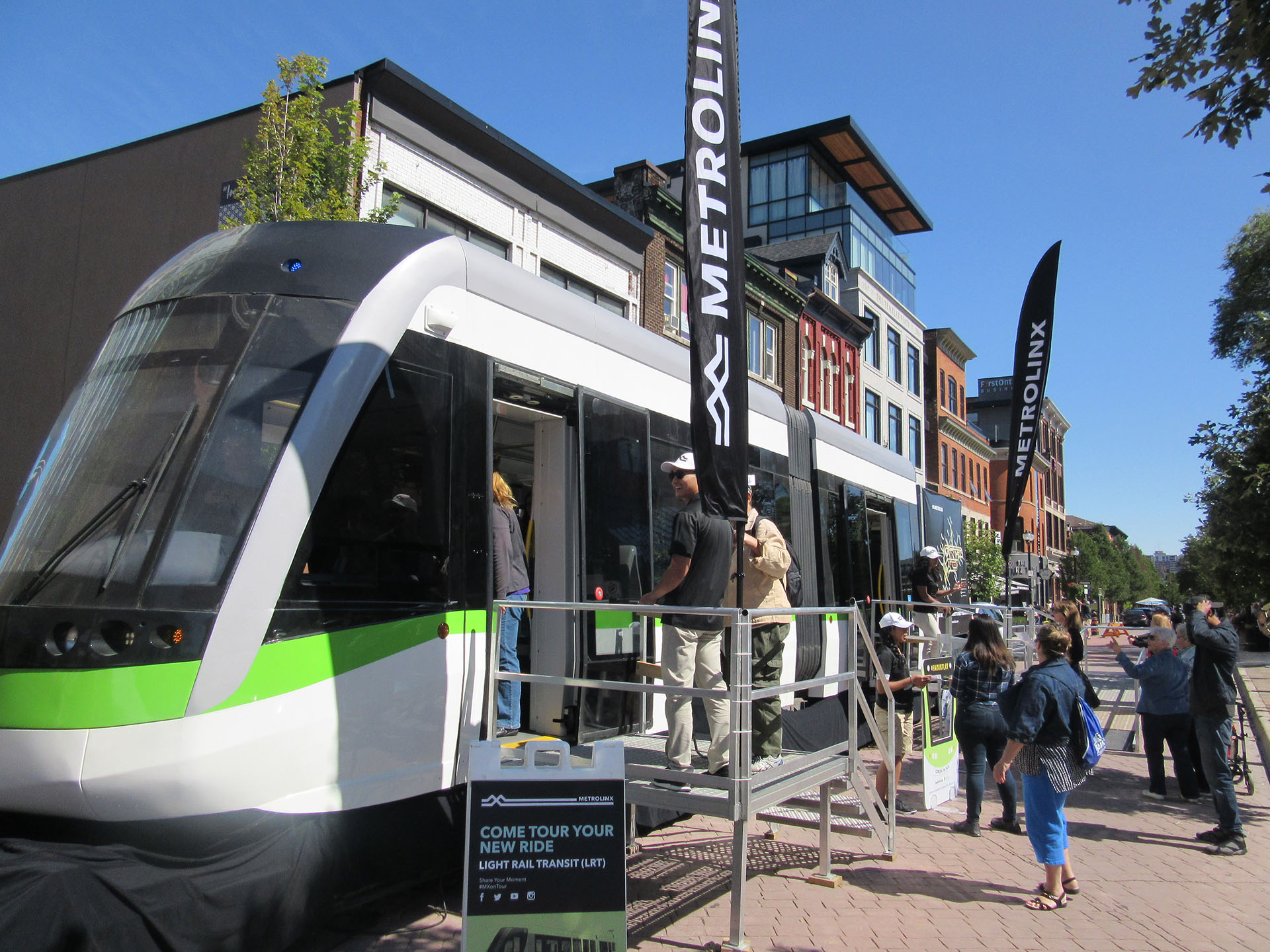 People entering a new Metrolinx light rail train display