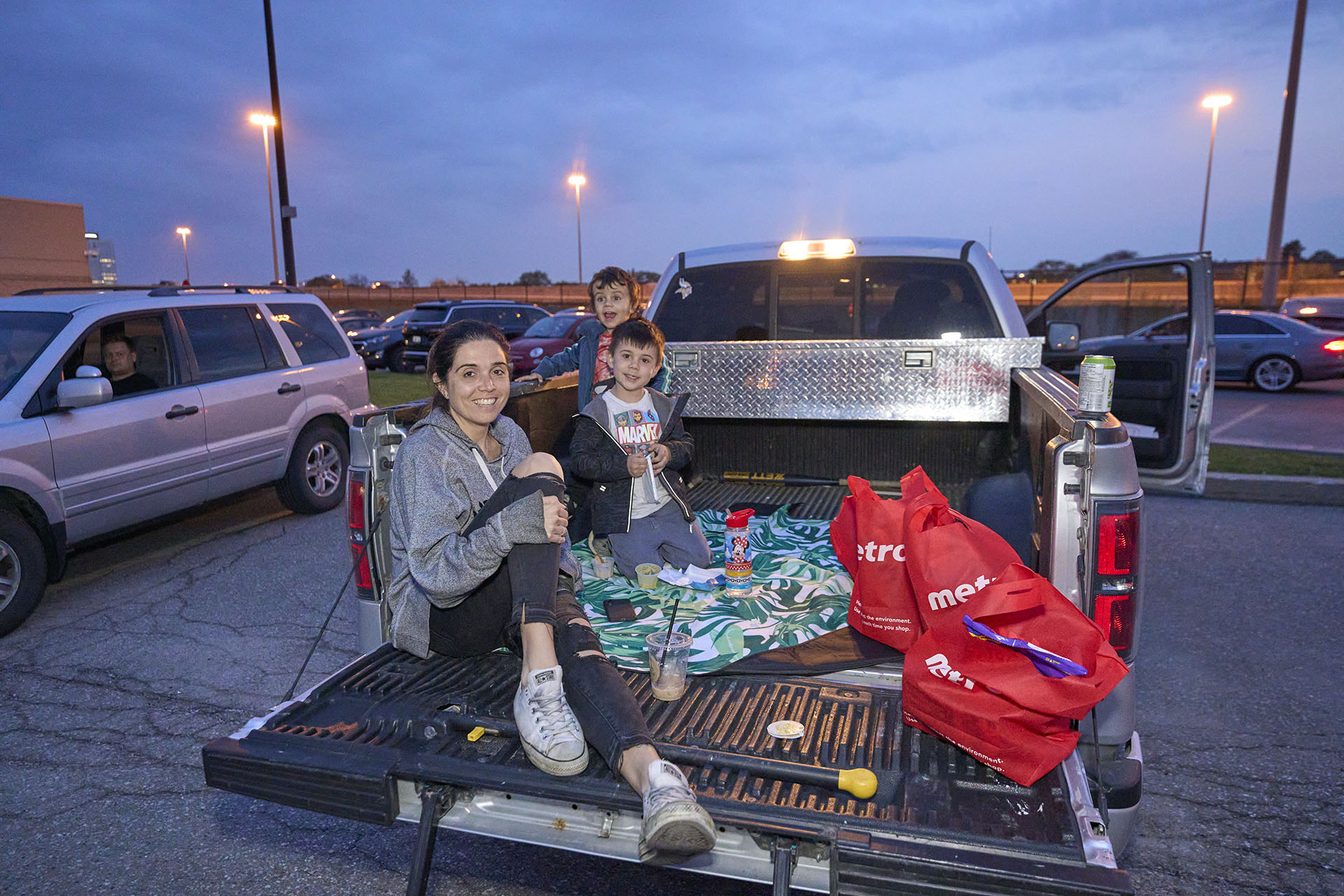 A family sitting in the back of a pickup truck