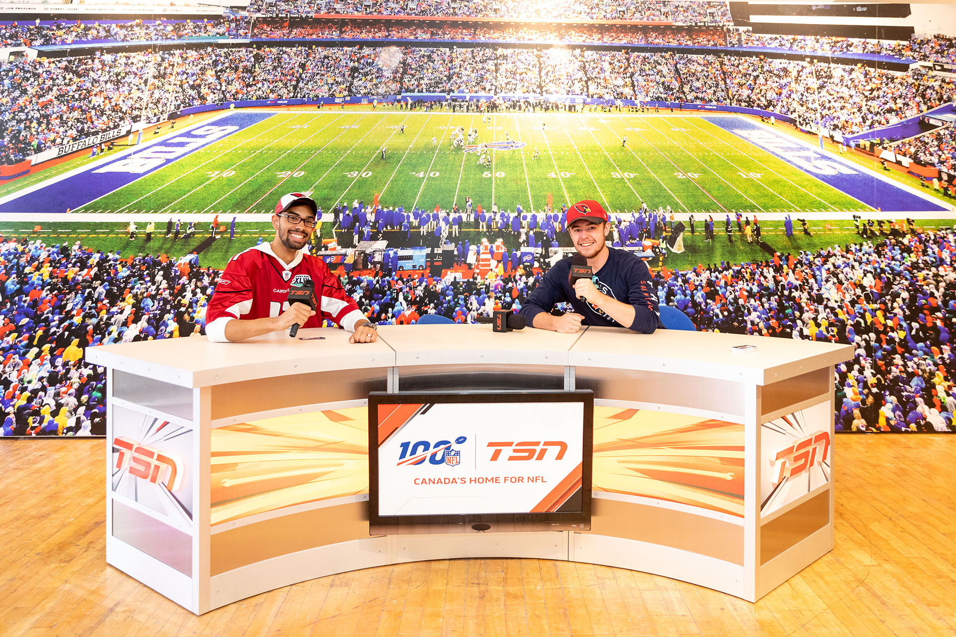 Attendees sitting at an NFL and TSN sports desk