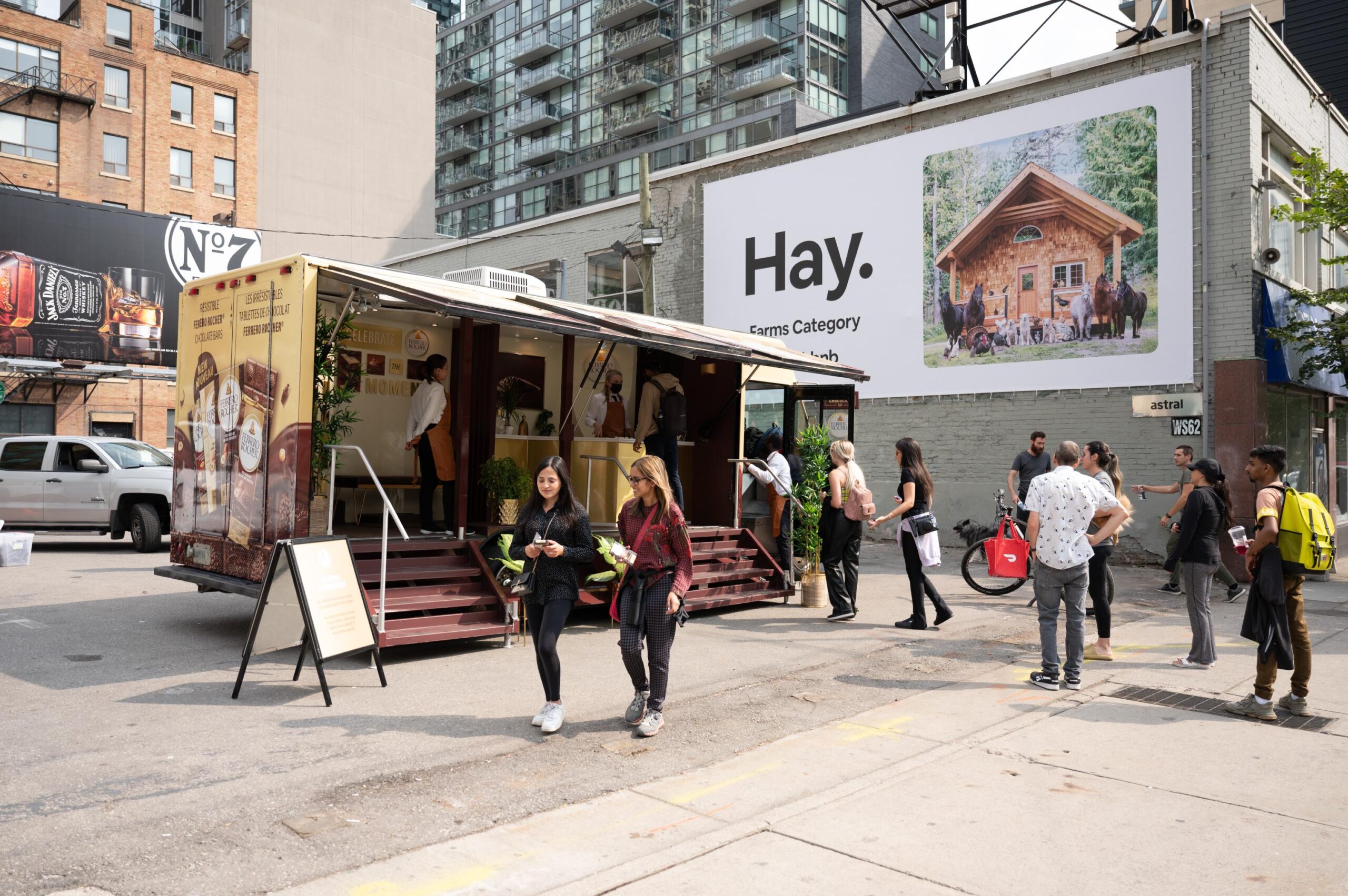 A group of people lining up at a Ferrero Rocher truck for samples