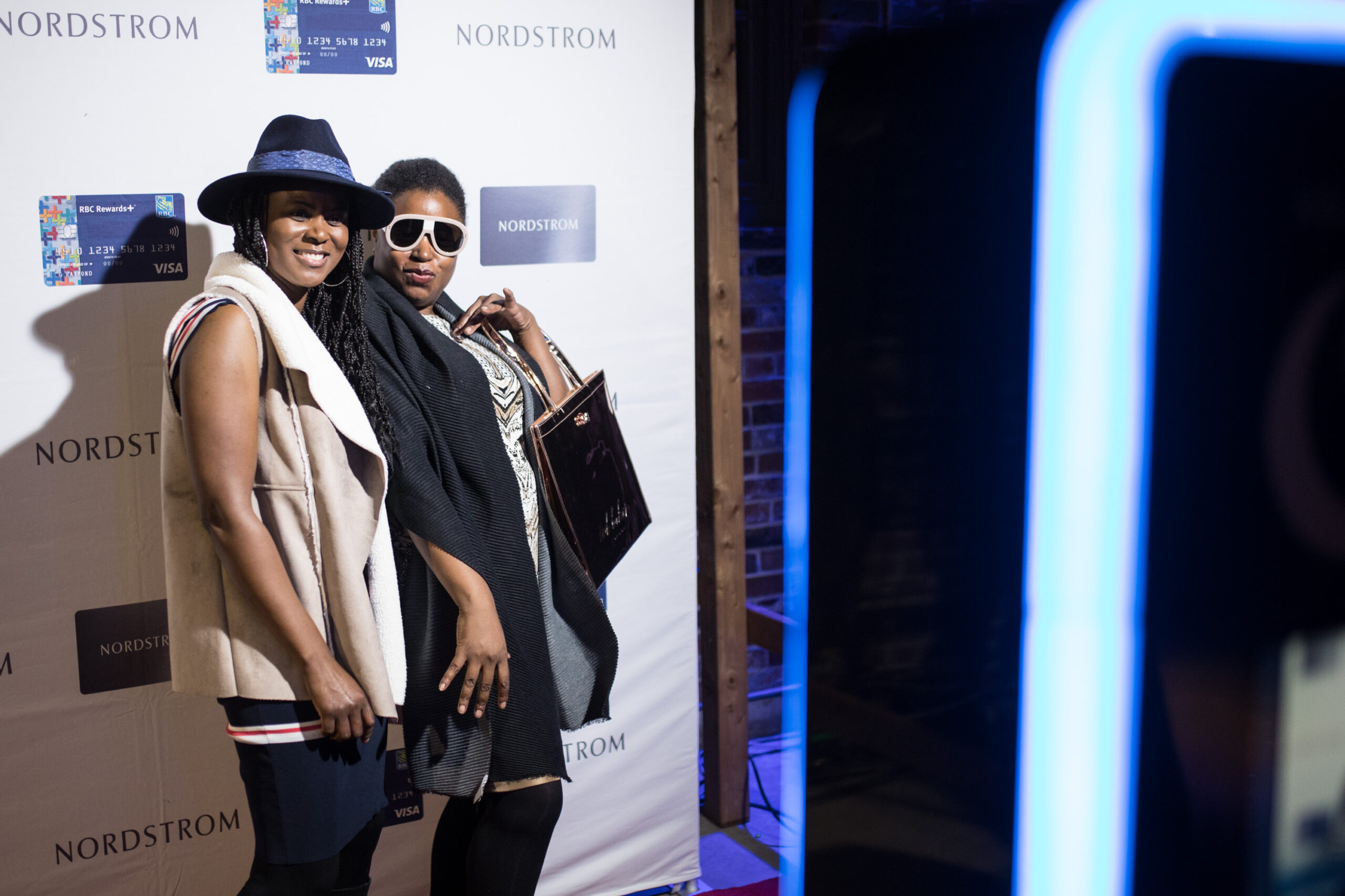 2 women posing in front of a Nordstrom sign