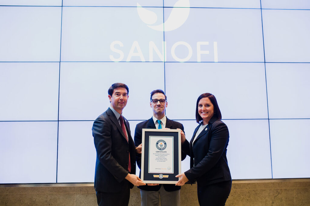 3 people posing with an award