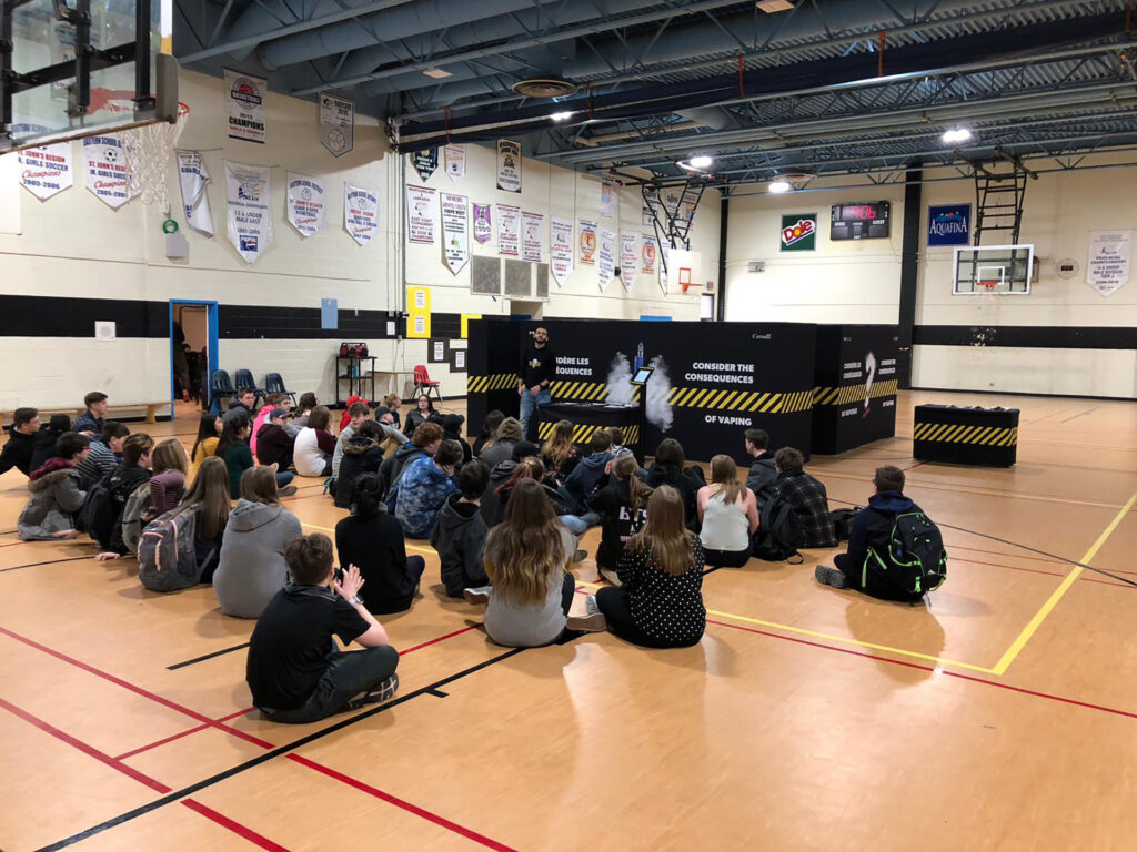 Students being briefed in a gym on the activity