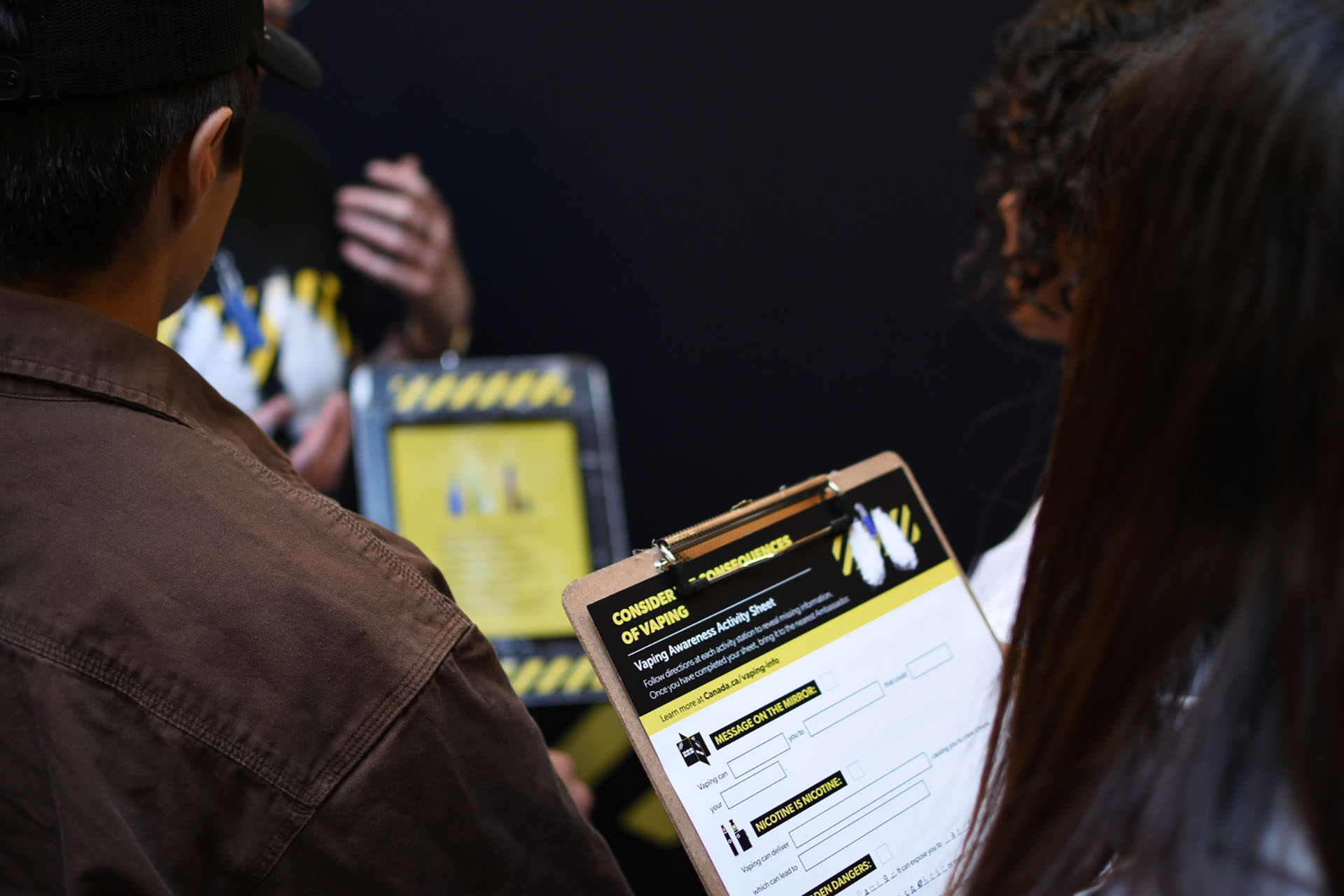 students standing together holding a clipboard