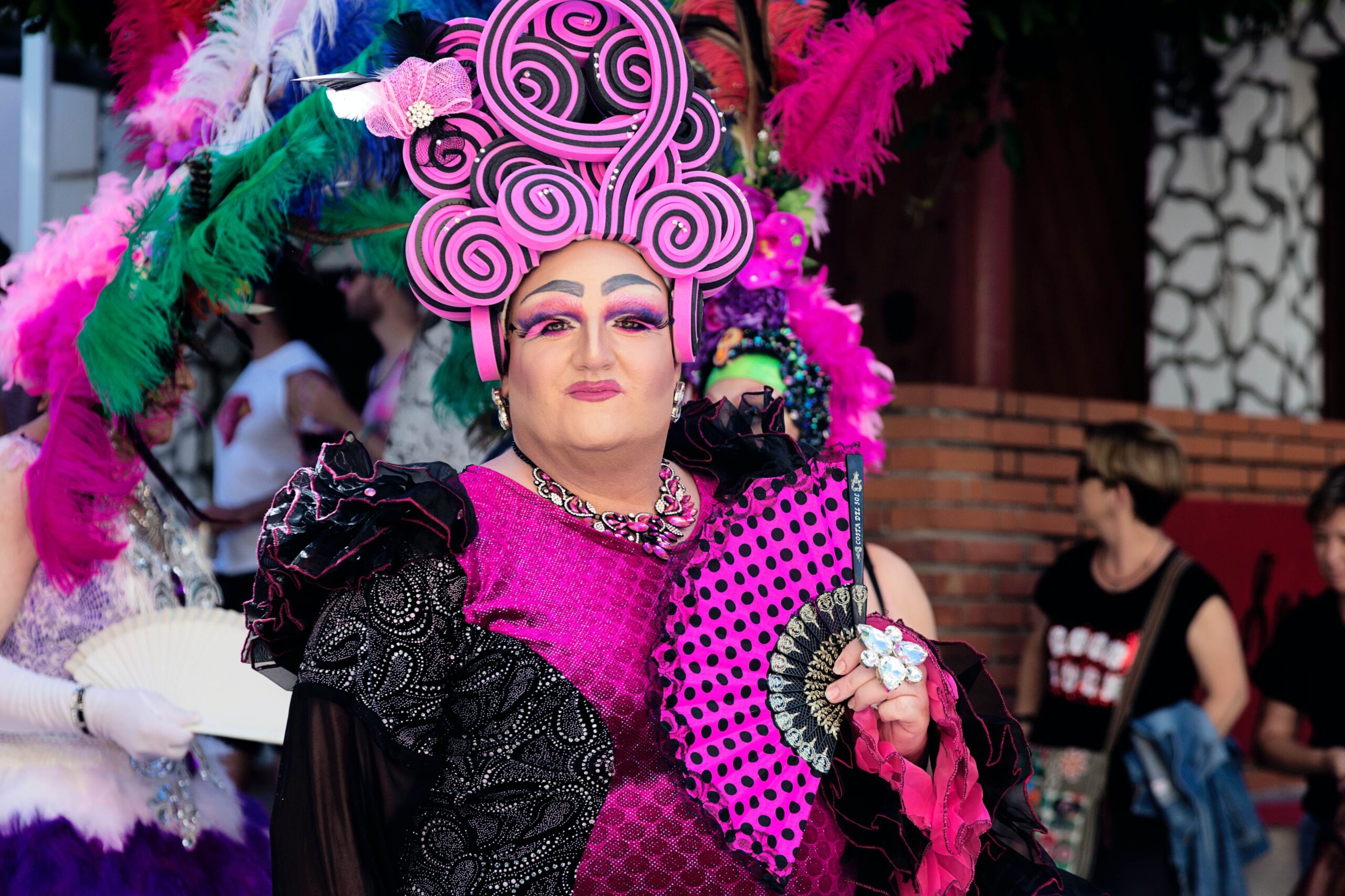 Drag queen at Pride, dressed in an elaborate pink outfit